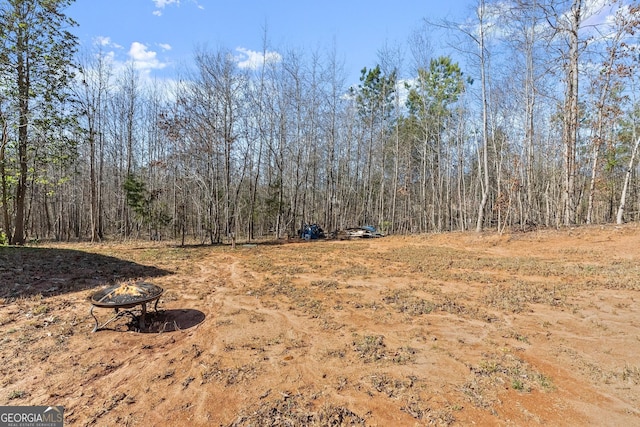 view of yard with a fire pit