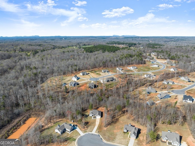aerial view featuring a wooded view