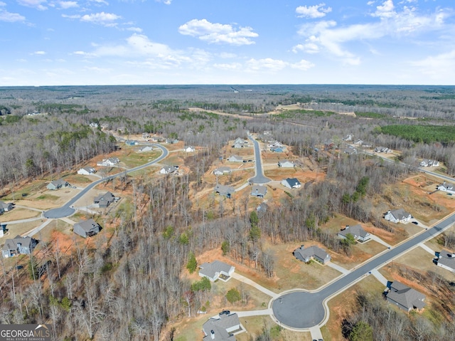 birds eye view of property with a forest view