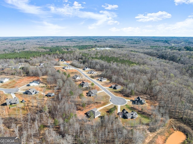 drone / aerial view with a wooded view