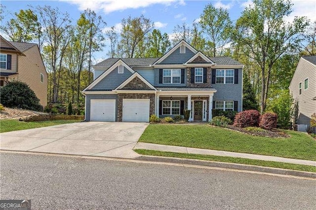 6655 Grove Meadows Ln, Cumming, GA 30028 - craftsman house featuring a front yard, stone siding, and driveway