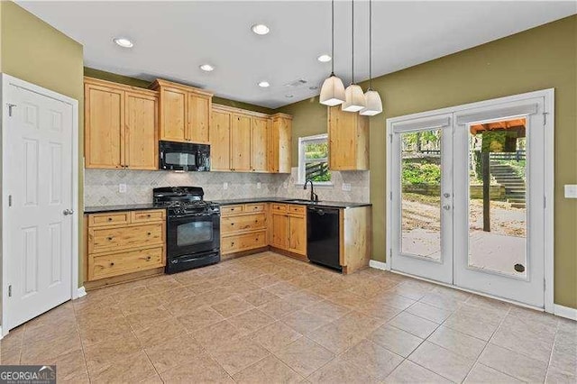 6655 Grove Meadows Ln, Cumming, GA 30028 - kitchen with decorative light fixtures, a sink, dark countertops, black appliances, and decorative backsplash