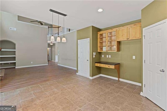6655 Grove Meadows Ln, Cumming, GA 30028 - kitchen featuring decorative light fixtures, glass insert cabinets, baseboards, and a ceiling fan
