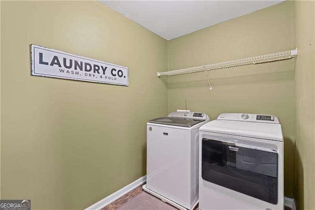 6655 Grove Meadows Ln, Cumming, GA 30028 - laundry room featuring washer and clothes dryer, laundry area, and baseboards
