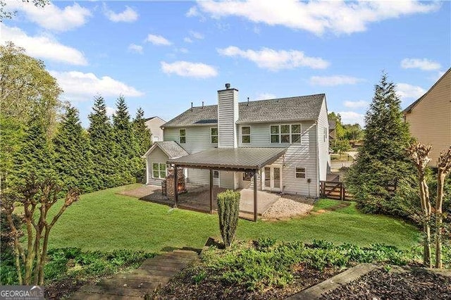 6655 Grove Meadows Ln, Cumming, GA 30028 - back of house with a patio, a chimney, and a lawn