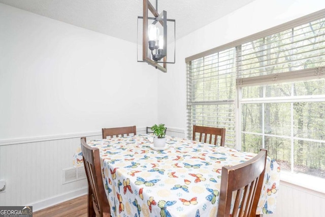 166 Rustin Dr, Dallas, GA 30157 - dining space with wood finished floors and a wainscoted wall