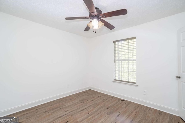 166 Rustin Dr, Dallas, GA 30157 - unfurnished room featuring wood finished floors, a ceiling fan, and healthy amount of natural light