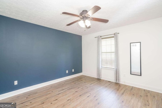 166 Rustin Dr, Dallas, GA 30157 - spare room with a textured ceiling, a ceiling fan, and wood finished floors