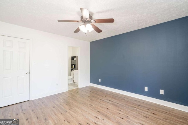 166 Rustin Dr, Dallas, GA 30157 - unfurnished bedroom with wood finished floors, a textured ceiling, ensuite bathroom, and a ceiling fan