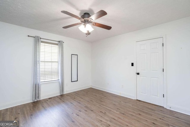 166 Rustin Dr, Dallas, GA 30157 - unfurnished room with wood finished floors, a ceiling fan, and a textured ceiling