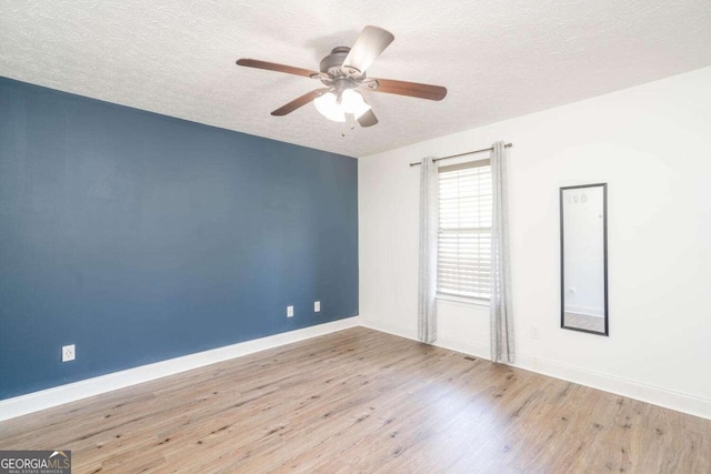 166 Rustin Dr, Dallas, GA 30157 - spare room with a textured ceiling, wood finished floors, and a ceiling fan