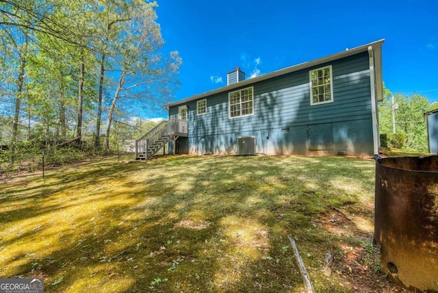 166 Rustin Dr, Dallas, GA 30157 - rear view of house with a chimney, a yard, stairs, and crawl space