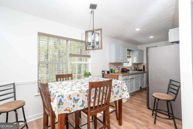 166 Rustin Dr, Dallas, GA 30157 - dining room with a chandelier, a wainscoted wall, a textured ceiling, light wood finished floors, and recessed lighting