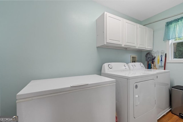 laundry room with washer and dryer and cabinet space