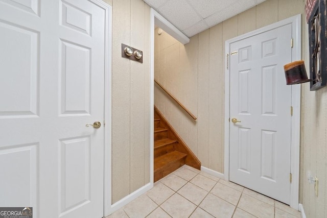stairs featuring tile patterned floors and baseboards
