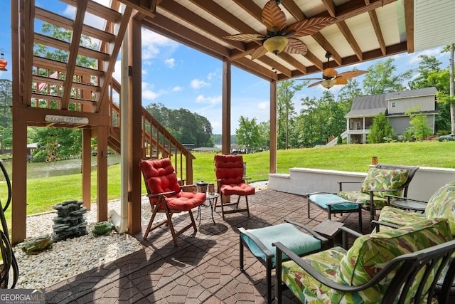 view of patio / terrace with a water view, stairs, and a ceiling fan