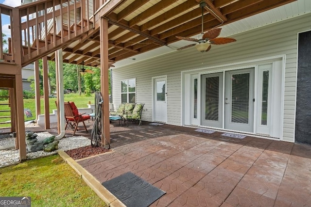 view of patio / terrace with stairway and ceiling fan