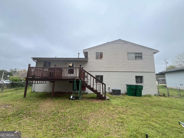 rear view of property with stairs, central AC unit, a deck, fence, and a lawn