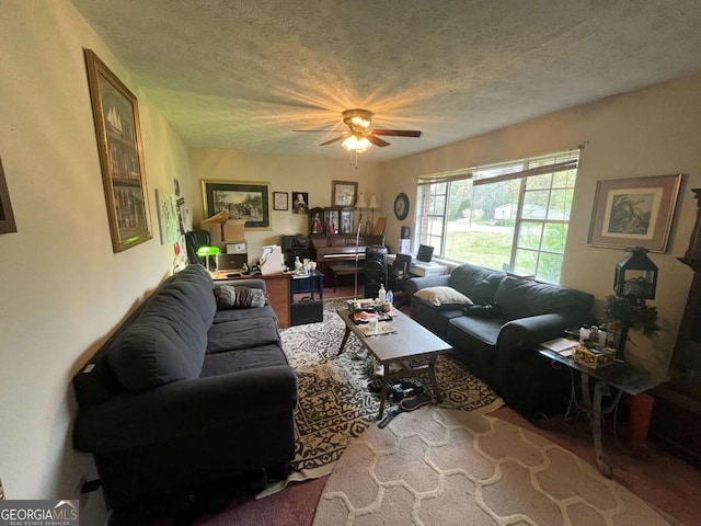 living area featuring a textured ceiling and ceiling fan
