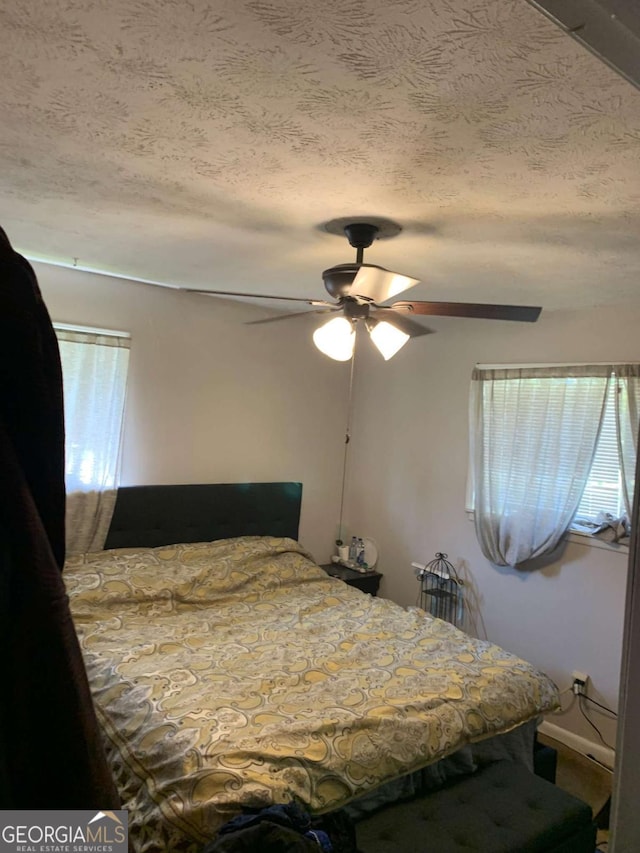 bedroom featuring a textured ceiling and ceiling fan