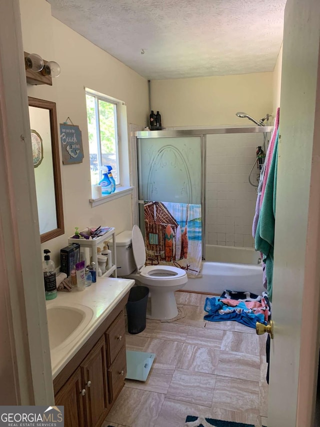 full bathroom with toilet, a textured ceiling, vanity, and bathtub / shower combination