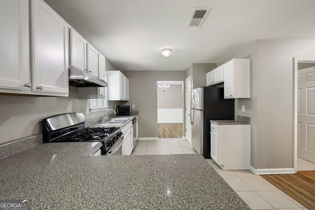 3571 Oakshire Way SE, Atlanta, GA 30354 - kitchen with light tile patterned flooring, under cabinet range hood, visible vents, appliances with stainless steel finishes, and a sink