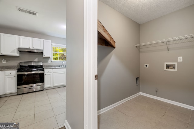 3571 Oakshire Way SE, Atlanta, GA 30354 - laundry room featuring hookup for an electric dryer, light tile patterned floors, visible vents, and laundry area