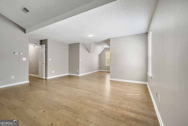 3571 Oakshire Way SE, Atlanta, GA 30354 - unfurnished living room featuring visible vents, baseboards, a textured ceiling, and wood finished floors