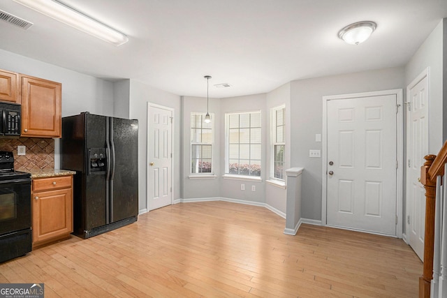 1728 Devon Dr SW, Atlanta, GA 30311 - kitchen featuring tasteful backsplash, light wood-style flooring, black appliances, baseboards, and visible vents