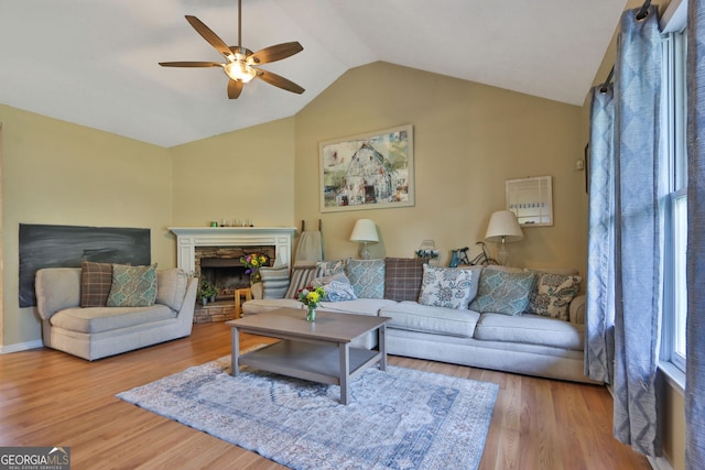 2675 Dacula Ridge Dr, Dacula, GA 30019 - living room with ceiling fan, vaulted ceiling, wood finished floors, and a fireplace