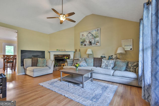 2675 Dacula Ridge Dr, Dacula, GA 30019 - living area with a ceiling fan, vaulted ceiling, wood finished floors, and a fireplace