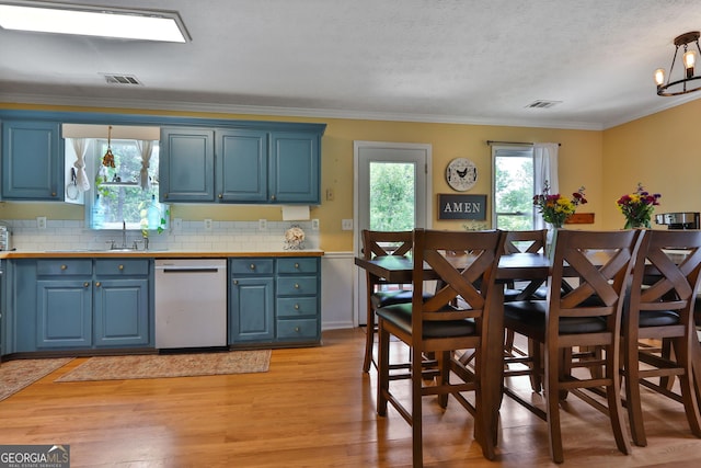 2675 Dacula Ridge Dr, Dacula, GA 30019 - kitchen with dishwasher, blue cabinets, plenty of natural light, decorative backsplash, and ornamental molding