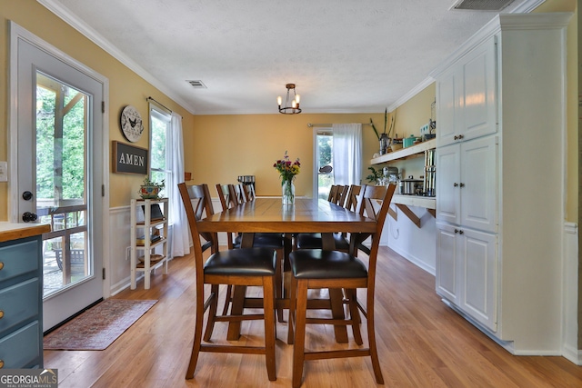2675 Dacula Ridge Dr, Dacula, GA 30019 - dining area with light wood finished floors, a chandelier, and ornamental molding