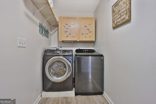 2675 Dacula Ridge Dr, Dacula, GA 30019 - laundry area featuring independent washer and dryer, cabinet space, and light wood finished floors