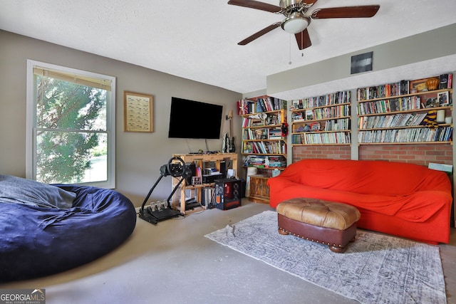2675 Dacula Ridge Dr, Dacula, GA 30019 - living area featuring concrete flooring, ceiling fan, and a textured ceiling
