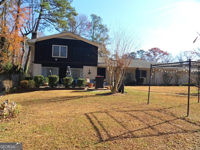 4213 Janice Dr, Atlanta, GA 30337 - back of house featuring a chimney and a lawn