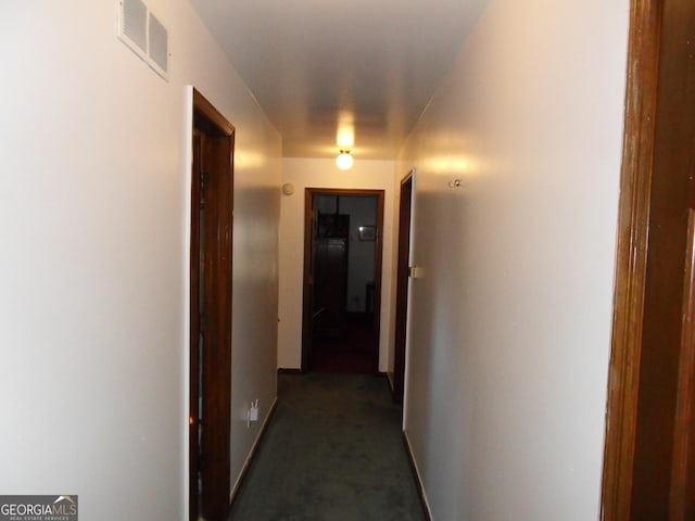 4213 Janice Dr, Atlanta, GA 30337 - corridor featuring baseboards, dark colored carpet, and visible vents