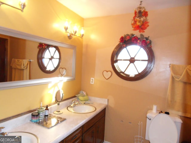 4213 Janice Dr, Atlanta, GA 30337 - bathroom featuring toilet, double vanity, and a sink