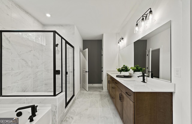 bathroom featuring baseboards, a sink, a shower stall, double vanity, and marble finish floor