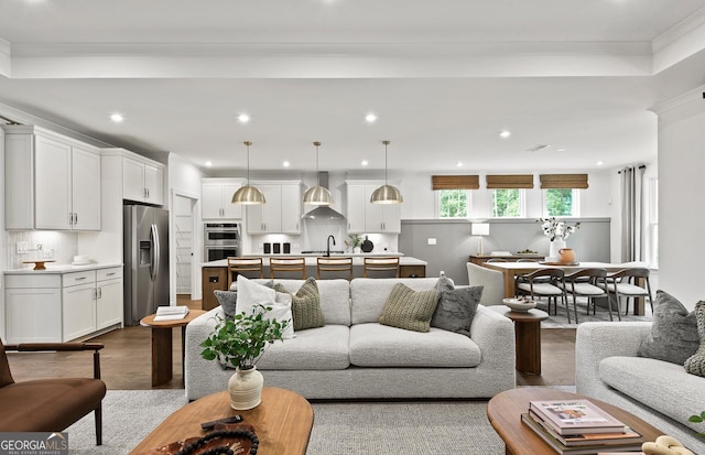 living area with recessed lighting, dark wood-type flooring, and crown molding