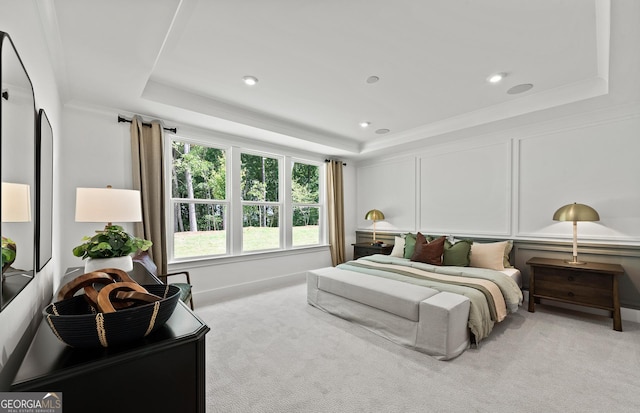 bedroom featuring a tray ceiling, recessed lighting, ornamental molding, and carpet floors