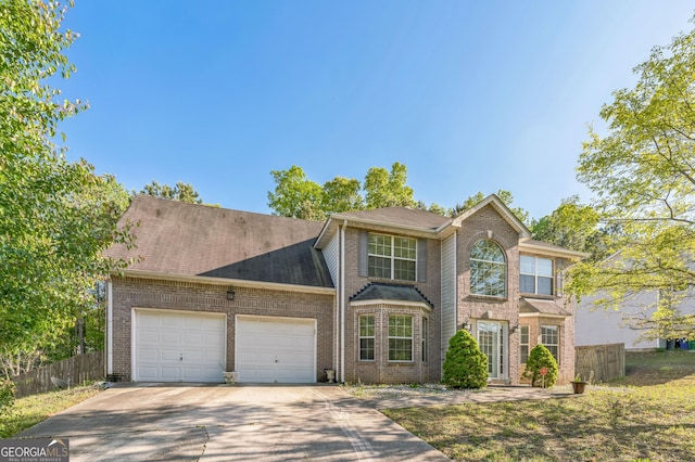 view of front of property with driveway, a garage, fence, and brick siding
