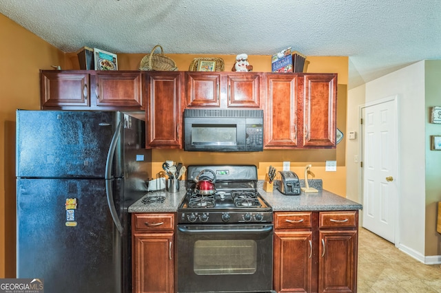 kitchen with a textured ceiling, light tile patterned floors, and black appliances