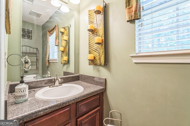 bathroom featuring vanity and visible vents