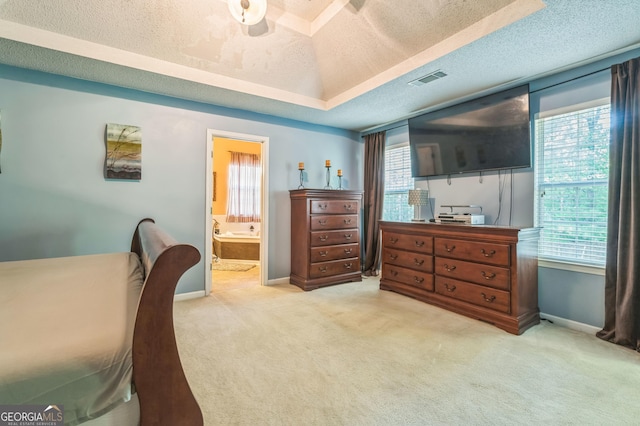 bedroom featuring visible vents, baseboards, multiple windows, and light colored carpet