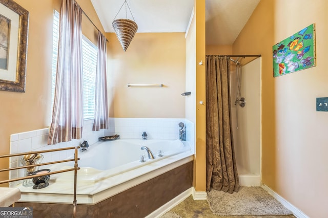 bathroom with a shower stall and a garden tub