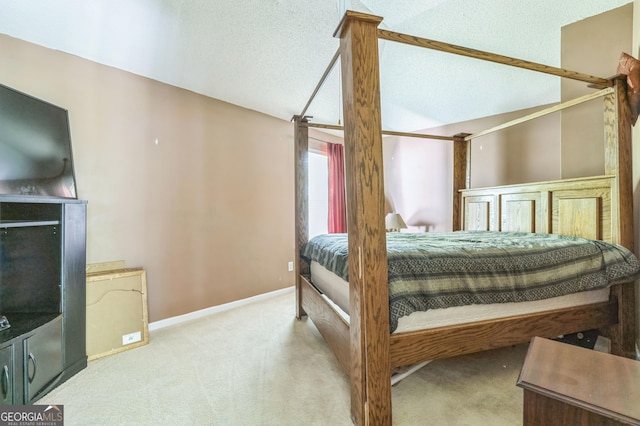 bedroom featuring baseboards, vaulted ceiling, and carpet