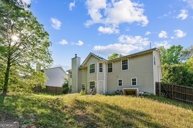 rear view of property with fence