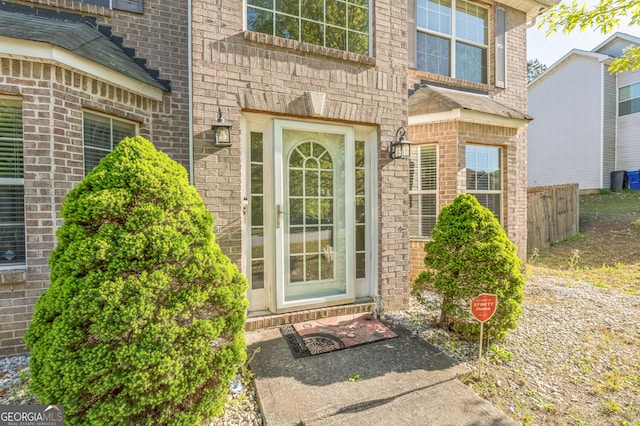 property entrance featuring brick siding