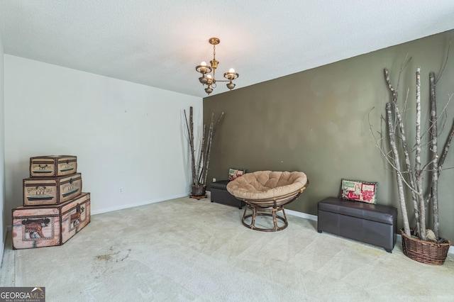 living area featuring a textured ceiling, carpet flooring, baseboards, and an inviting chandelier